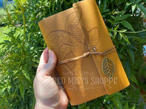 Falling Leaves Fawn Vegan Leather Journal, Book of Shadows, Tarot Journal, Blank Grimoire, Dream Journal, Witch's Blank Ritual & Spell Book held in a hand to show size.