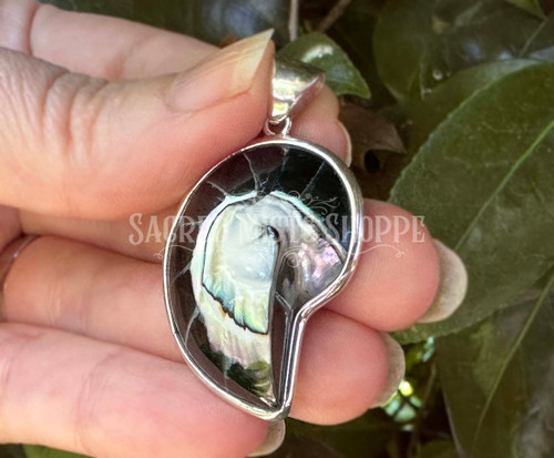 Crafted with attention to detail, this pendant seamlessly blends the shimmering elegance of black lip shell, mother of pearl, and abalone, set in sterling silver.