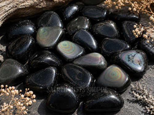 Close-up of Natural Rainbow Obsidian crystals displaying shimmering iridescence across polished volcanic glass.