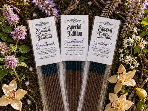 Three packs of Sacred Mists Shoppe incense lying on a bed of mossy botanicals.