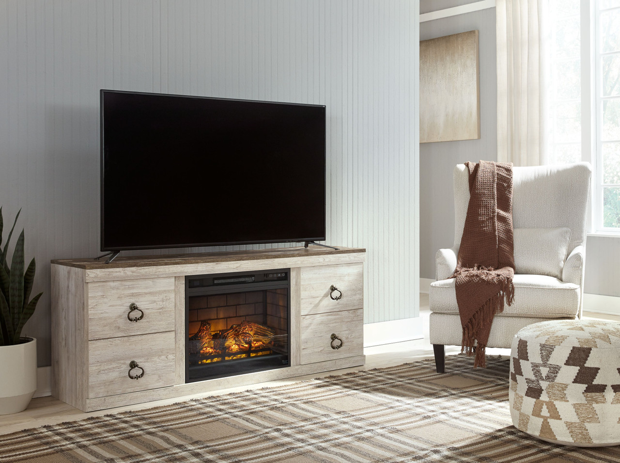 The Willowton Whitewash TV Stand With Electric Fireplace sold at Hilton  Furniture serving Houston, TX and surrounding areas.