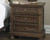 Flynnter Medium Brown 7 Pc. Dresser, Mirror, Chest, King Panel Bed with Storage & Nightstand