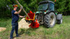 Remet RT-630R PTO Disc Chipper with tractor in use viewed from the right rear