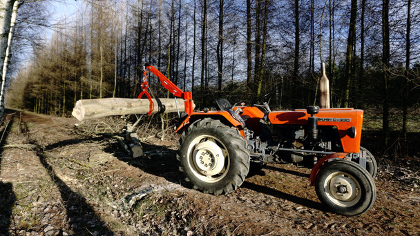 Remet C250 Tractor Crane moving a log.