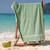36x68 Green Pool Towels 36x68, shown draped over a chair at the beach