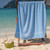 36x68 Blue Pool Towels 36x68, shown draped over a chair at the beach