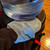 Blue Microfiber Dusting Mitts with Thumb, shown cleaning a water bubbler