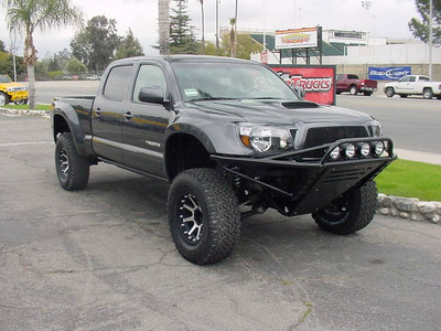 Icon Vehicle Dynamics 2.5" Remote Reservoir Front Coilover's, Total Chaos Fabrication Uniball Upper Control Arm, Deaver 1.5" Rear Leaf Pack, Icon Vehicle Dynamics 2.0" Remote Reservoir Rear Shocks, Glassworks Unlimited Front and Rear Fiberglass Fenders Painted To Match, 17x9 KMC XD Addict Wheels Black and Machined Finish, 305/65/17 BF Goodrich A/T Tires, Pro Comp Black Lug Nut Set, Anzo Black Front Headlamp Kit, Cycolite H.I.D. Headlight Conversion Kit, T-Rex Black Billet Grille Set, SoCal Supertrucks Fabricated Front and Rear Custom Bumpers Powdercoated Black, Baja Designs Fuego H.I.D. Spot and Driving Lights, Smoked Factory Rear Tailights and 3rd Brake Light, PIAA Reverse Lamp Kit, SoCal Supertrucks Body Mount Plate Kit, 1.25" Front Wheel Adapters, Total Chaos Fabrication Spindle Gusset Kit