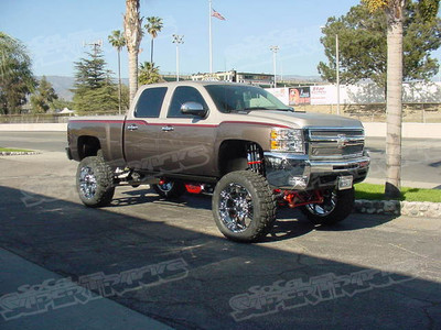CST Performance 9" Suspension Kit, CST Performance Pro Joint Dual Shock Control Arms, CST Performance Front Driveshaft, Deaver Springs 6" Rear Leaf Pack, CST Performance Dual Rear Shock Bracket Kit, Fox Racing Shox Chrome and Black Remote Reservoir Shocks, Socal Supertrucks Custom Powdercoated Billet Shock Clamps, Socal Supertrucks HD Heim Steering Kit, Socal Supertrucks Custom Traction Bar Kit, Amp Research Power Steps, 24x11 MKW M26 Wheels Chrome Finish, 38x14.00x24 Kuhmo Road Venture M/T Tires, Mag Hytech Rear Diff Cover, Magnaflow Cat-Back Exhuast Kit