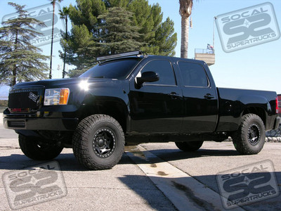 This 2011 GMC Sierra Denali 2500HD Was Built For AMA Motocross/Supercross Standout, Blake Baggett. Blake's Goal For His Truck Was Badass Looks, Power On Tap, And Suspension That Could Handle Some Bumps Out In The Rough Stuff. To Make Sure All Of This Was Achieved, We Used ICON Vehicle Dynamics' Uniball Upper Control Arms Paired With ICON 2.5" Piggyback Reservoir Front Shocks. In The Rear 2.5" ICON Piggyback Shocks, Lowering Shackles, And An Overload Spring Removal Were All Used To Get The Look And The Function Blake Was Hoping For. 17" Walker Evans Racing Beadlock Wheels In A Custom Black Powdercoat Were Mounted Up With 35x12.50x17 General Grabber Tires To Give The Denali That "Stealth" Feel. SoCal SuperTrucks Custom GM Lightbar Mounts Were Used To Place A 50" Rigid Industries LED Lightbar Above The Windshield Without Drilling Into The Roof Of The Truck, While Another 20" Lightbar Was Mounted Up In The Front Bumper. SoCal SuperTrucks Custom Grille Badges Were Bolted Onto Black Mesh X-Metal Grilles For Even More Of A Trick Look. Power Comes From An AFE Cold Air Intake System, AFE Deleted Exhaust System, and H&S Diesel Programmer, While A Mag-Hytec Rear Diff Cover Was Installed To Help Everything Stay Cool Under A Load