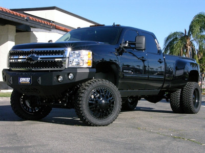 CST Performance Suspension 6" Lift System, CST Steering Stabilizer Kit, FOX 2.0 Remote Reservoir Rear Shocks, SoCal SuperTrucks Billet Reservoir Clamps in Black Finish, 22" American Force 'Freedom' Chrome Wheels & 35x12.50x22 Toyo Open Country M/T Tires. Additional Upgrades Include a T-Rex 'X-Metal' Grille, a Black Billet Chevy Bowtie Emblem, Road Armor 'Stealth' Front & Rear Bumpers in a Black Finish, a Viair X-treme Duty Onboard Air System, Hornblasters 'Shocker XL' Train Horns, Husky 5th Wheel Hitch, H.I.D. Headlight Conversion & an AFE Cold-Air Intake System