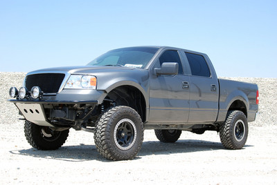 Camburg's Performance 7.0 Coilover System, Which Converts The Stock Suspension and Steering Components To Pre-Runner Style Fabricated Uniball Spindles, Tubular Upper Control Arms and Full Heim Steering. Custom ICON Vehicle Dynamics 2.5" Remote Reservoir Coilover Front Shocks, 2.5" Piggyback Rear Shocks, 3" Deaver Leaf Springs and Shackles Provide A Smooth Ride When Things Get Rough. Glassworks 4" Flare, 3" Rise Fiberglass Fenders Give The 17" ProComp #8128 Wheels and 285/75R17 Toyo M/T Tires Room To Travel In The Dirt. After All Is Said and Done, This F150 Makes A Nice Daily Driver That Can Double As A Weekend Warrior's Pre-Runner