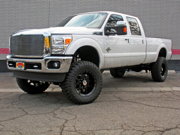 This vehicle has a 7" ICON Vehicle Dynamics Coilover Conversion Kit utilizing ICON's 2.5" Dual-Rate Coilover shocks, 2.5" Piggyback Reservoir Secondary Front Shocks, 4-Link System, ICON Dual Steering-Stabilizer Kit, Adjustable Pan-Rod Bar, 2.5" VS Series Piggyback Reservoir Rear Shocks & a SoCal SuperTrucks Custom Long-Travel Rear Air Bag Setup Filled by a Viair Heavy-Duty Onboard Air System. Other additions include AMP Research Powersteps, an H.I.D. Headlight Conversion, a T-Rex Billet Grille Insert, Mag-Hytec Rear Differential Cover & Gloss Black 20"x10" RBP '91R' Wheels Wrapped With 37x13.50x20 Toyo Open Country M/T Tires