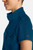 The HH752 Quest Bella Women’s Partial Zip Stand Collar Top is shown in a close‑up view emphasizing its Caribbean Blue short‑sleeve construction, smooth partial‑zip collar, and practical chest pocket holding a pen. The clean, professional detailing reinforces its purpose as a dependable uniform top for healthcare, hospitality, and other active roles.