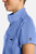 The HH752 Quest Bella Women’s Partial Zip Stand Collar Top is shown in a close‑up view emphasizing its ceil blue short‑sleeve construction, smooth partial‑zip collar, and practical chest pocket holding a pen. The clean, professional detailing reinforces its purpose as a dependable uniform top for healthcare, hospitality, and other active roles.