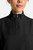 The HH752 Quest Bella Women’s Partial Zip Stand Collar Top is shown in a close‑up view emphasizing its black short‑sleeve construction, smooth partial‑zip collar, and practical chest pocket holding a pen. The clean, professional detailing reinforces its purpose as a dependable uniform top for healthcare, hospitality, and other active roles.