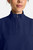 The HH752 Quest Bella Women’s Partial Zip Stand Collar Top is shown in a close‑up view emphasizing its navy blue short‑sleeve construction, smooth partial‑zip collar, and practical chest pocket holding a pen. The clean, professional detailing reinforces its purpose as a dependable uniform top for healthcare, hospitality, and other active roles.
