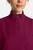 The HH752 Quest Bella Women’s Partial Zip Stand Collar Top is shown in a close‑up view emphasizing its Wine short‑sleeve construction, smooth partial‑zip collar, and practical chest pocket holding a pen. The clean, professional detailing reinforces its purpose as a dependable uniform top for healthcare, hospitality, and other active roles.