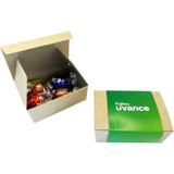 A box containing four Lindt chocolate balls in assorted colours, with a second opened box beside it.