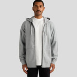 A grey zip-up hoodie with a front opening and two pockets, worn by a male model. It includes a hood and long sleeves.