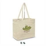 A cream cotton tote bag with sturdy handles and a logo depicting a farmhouse and fields.