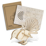 A wooden model of a fantail bird in natural wood colour, accompanied by a pre-cut assembly template and packaging.