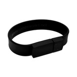 A rectangular black silicone wristband flash drive with a simple connector and a logo.