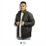 A man wearing a black puffer jacket with a zippered front and high collar, featuring a logo.