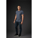A striped navy and white crew neck t-shirt displayed on a model, paired with dark jeans and shoes.