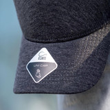 A dark grey cap with a structured brim and a logo on the side. It features a branding tag on the front.