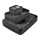 A set of three black packing cubes with mesh and solid compartments, featuring a logo on the smallest cube.
