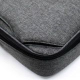A grey laptop bag featuring a textured fabric and a zip closure. It includes a branding logo.