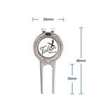 A metal golfers divot repair tool with a circular ball marker, featuring a logo and measuring 80mm by 35mm.
