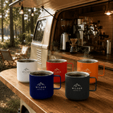 A set of five stainless steel coffee cups in white, red, orange, black, and a logo visible on each cup.