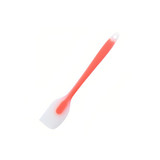 A silicone spatula with a red handle and a white head, featuring a hanging hole for easy storage.