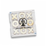 A Tic Tac Toe board game coaster with a clear base featuring wooden X and O pieces and a logo in the centre.