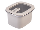 A rectangular microwave-safe container in cream with a transparent lid and a metal rim, featuring a handle.