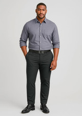 A man stands wearing a grey shirt and black stretch chino pants, complemented by a black belt and shoes.