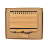 A bamboo notebook and silver pen set displayed in a kraft gift box with a black elastic band.