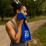 A woman in a grey tank top holds a blue cooling towel to her face, set in a green outdoor location. A woman in a grey tank top holds a blue cooling towel to her face, set in a green outdoor location.