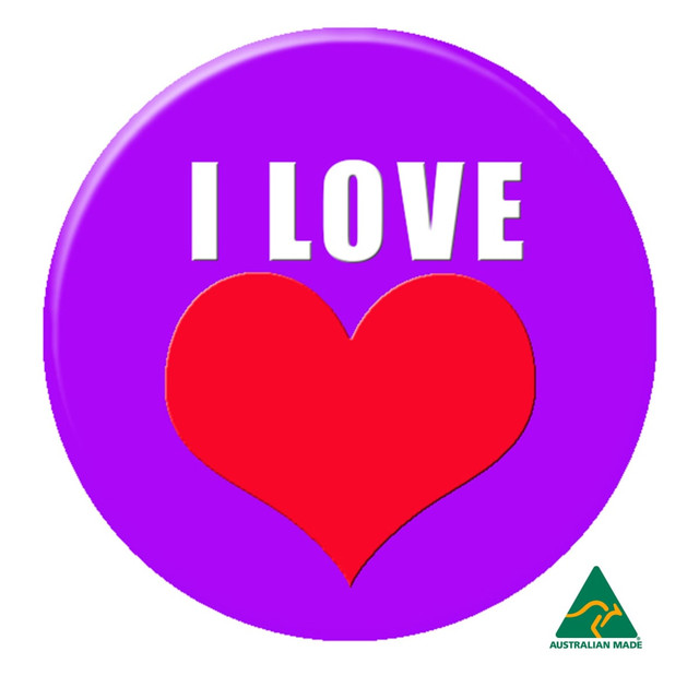 A purple 37mm button badge featuring a red heart and white text. It has a logo at the bottom.