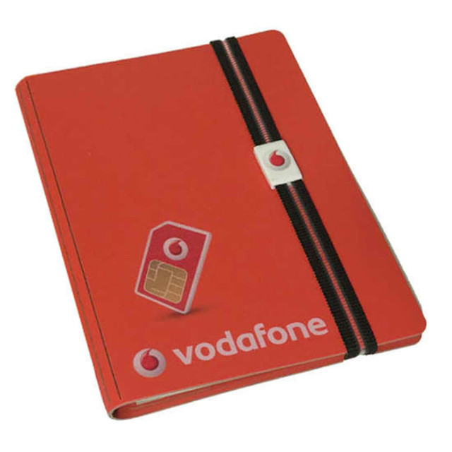 A5 bonded leather notebook in red with an elastic band and clip, featuring a logo on the cover. A5 bonded leather notebook in red with an elastic band and clip, featuring a logo on the cover.