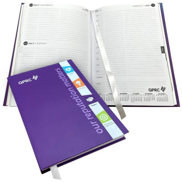 A5 laminated hard cover diary in purple, featuring a ribbon marker and a structured day-to-page layout. A5 laminated hard cover diary in purple, featuring a ribbon marker and a structured day-to-page layout.