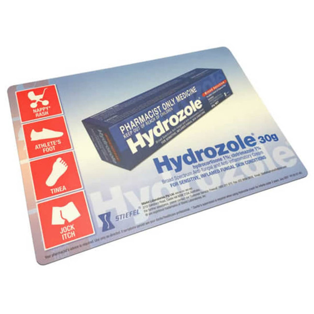 A counter mat displaying a product with a blue and white box, featuring various health-related icons and a logo. A counter mat displaying a product with a blue and white box, featuring various health-related icons and a logo.