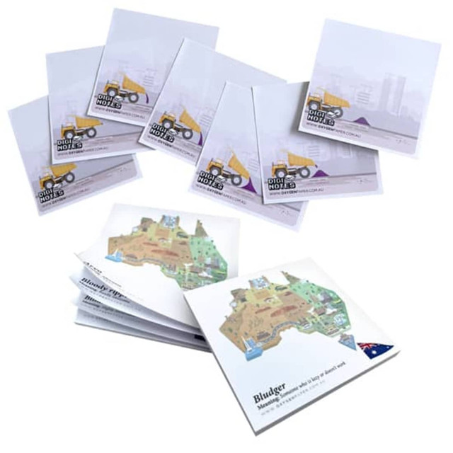 A set of notepads in white with illustrations, featuring construction themes and an Australian map design, and includes branding. A set of notepads in white with illustrations, featuring construction themes and an Australian map design, and includes branding.