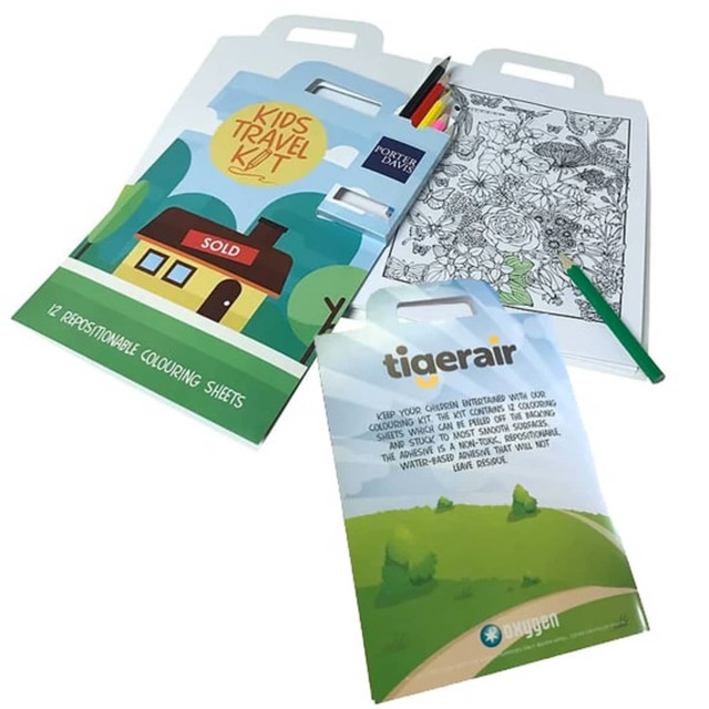 A travel kit featuring a colouring book, coloured pencils, and a logo, all in vibrant colours.