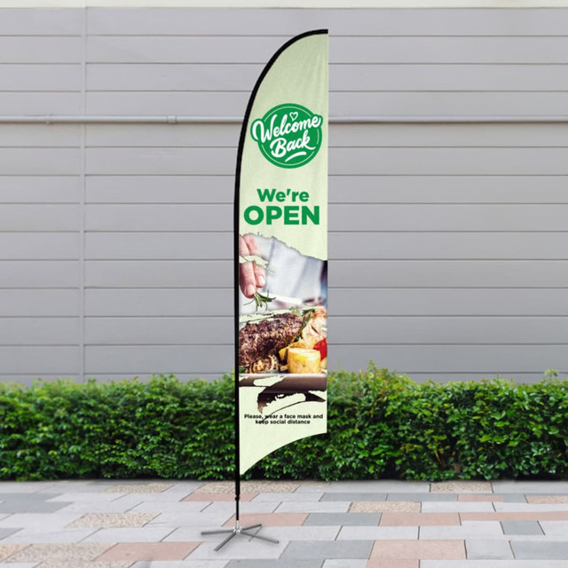 A large feather flag kit featuring a green and white design with a logo and image of food. It has a black pole and base.
