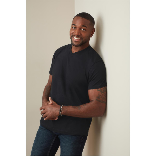 A black men's classic V-neck T-shirt displayed on a model against a light wall. The model is smiling and standing casually.