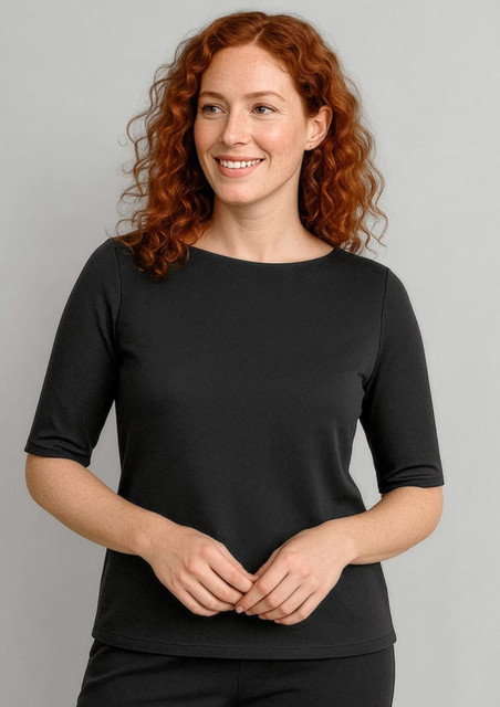 A black short sleeve T-shirt featuring a round neckline, worn by a woman with curly red hair.