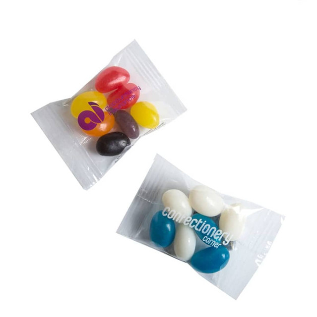 Two clear plastic bags containing assorted mini jelly beans in various colours, including red, yellow, black, blue, and white.